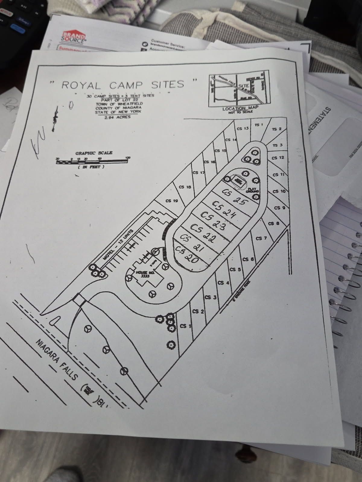 Camp site map showing plot layouts, roads, and surrounding area.