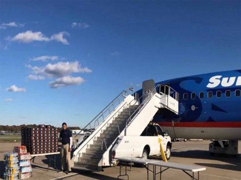 Deven on the Stairs of an Airplane
