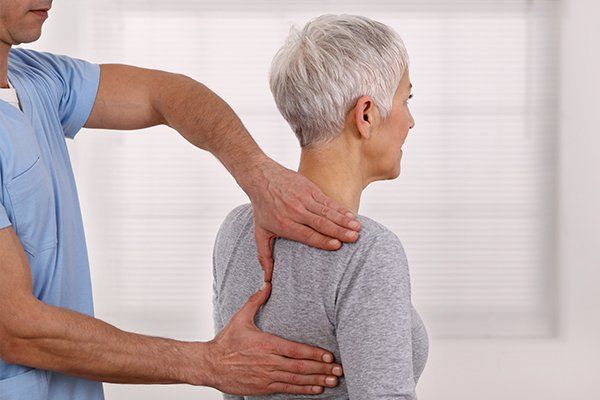 Woman Having Chiropractic Back Adjustment — Grand Forks, ND — ChiroCenter One
