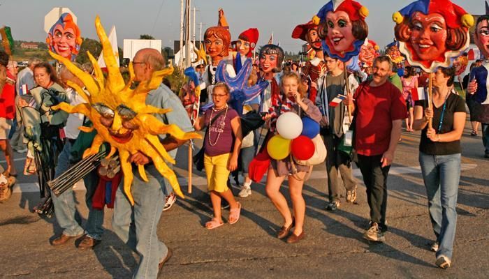 A group of people wearing masks are walking down a street