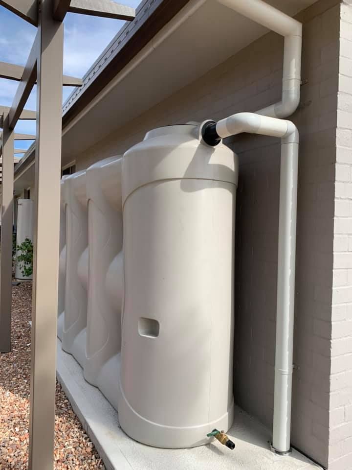 A Large White Water Tank Is Attached To The Side Of A House – Moore Creek, NSW - Thrift Plumbing Pty Ltd