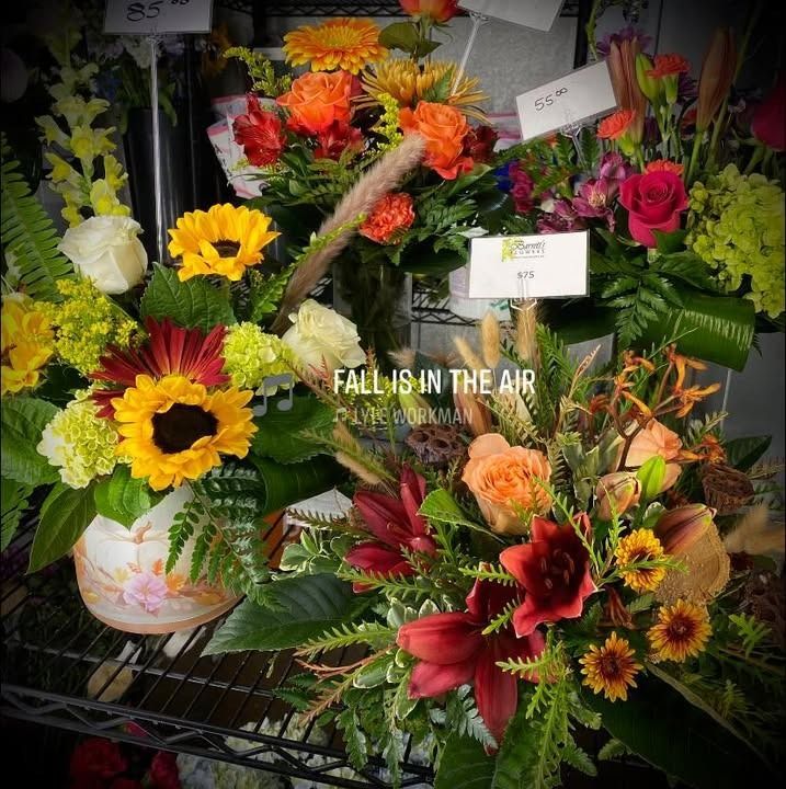 Fall floral arrangements with sunflowers, roses, and various autumnal colors.