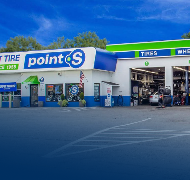 A point s tire and tires shop with cars parked in front of it | TNT Tire Point S Auto Service