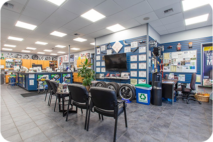 A large room with a lot of chairs and a tv on the wall | TNT Tire Point S Auto Service