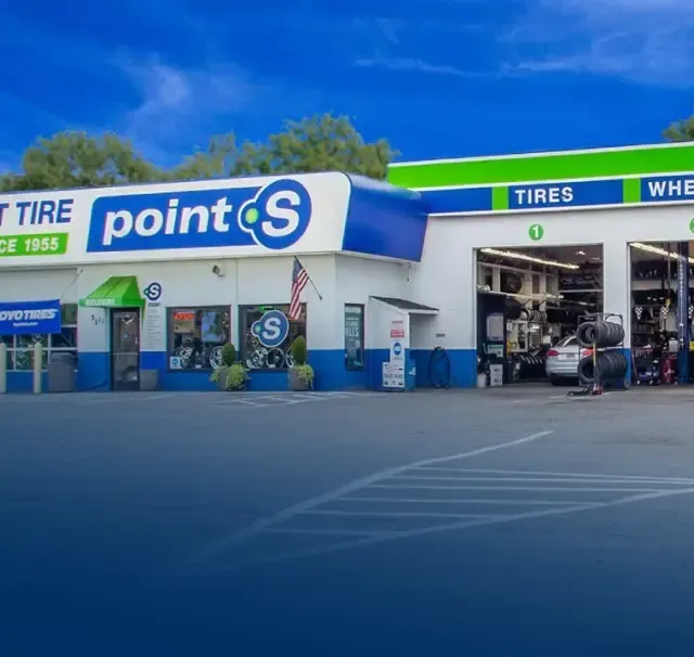 A point S tire and tires shop with cars parked in front of it | TNT Tire Point S Auto Service