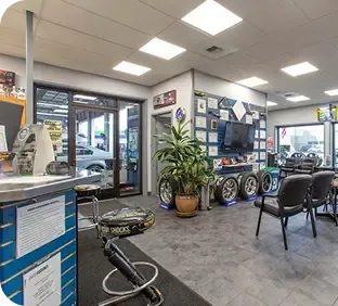 A showroom with a lot of tires on the floor | TNT Tire Point S Auto Service