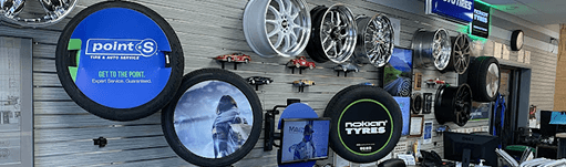 A store filled with lots of wheels and tires. | TNT Tire Point S Auto Service
