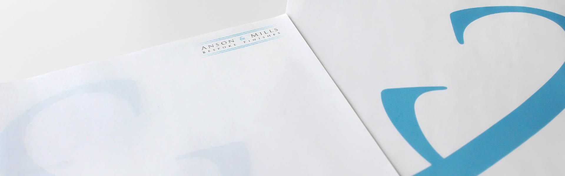 A close up of a piece of paper with the anson and mills logo on it.