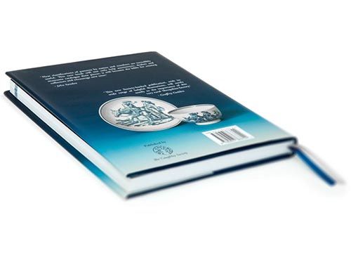 a close up of the back of a copy of the caughley blue and white patterns book on a white background