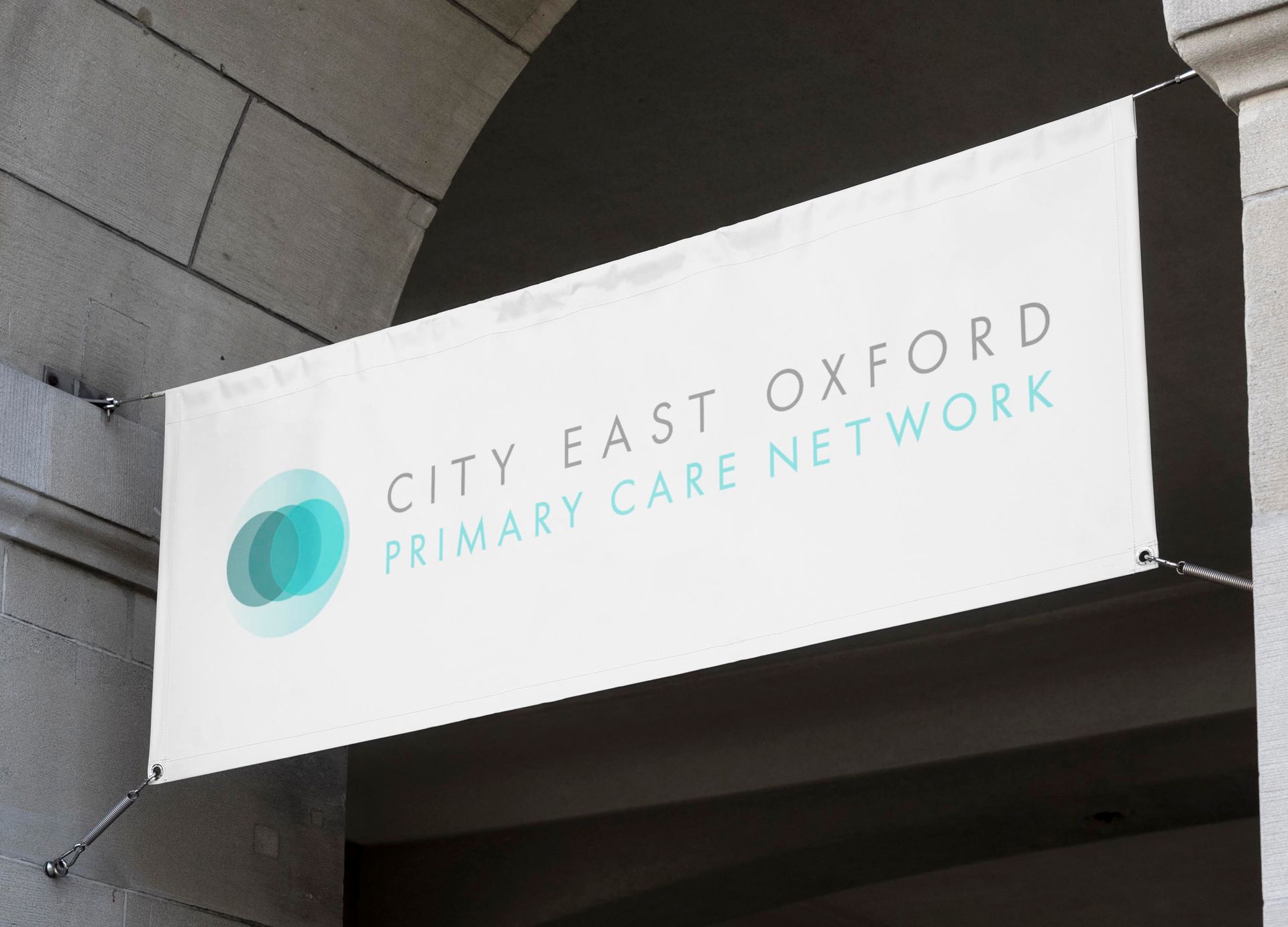 A city east oxford primary care network banner hangs from a building