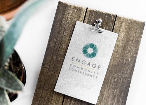 a clipboard with a logo on it is sitting on a wooden table .