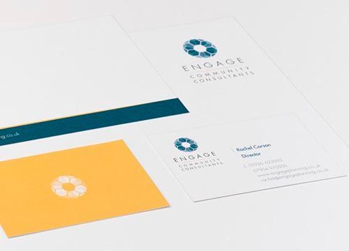 a close up of a business card and letterhead for engage community consultants .