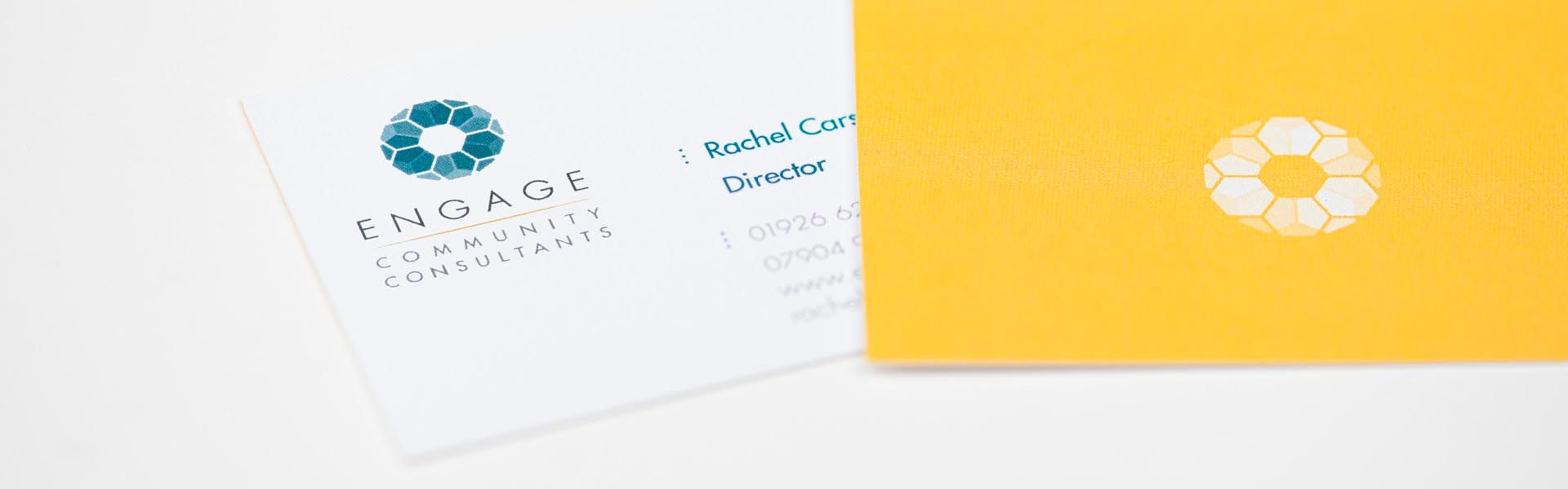 a business card for engage community consultants sits next to a yellow envelope