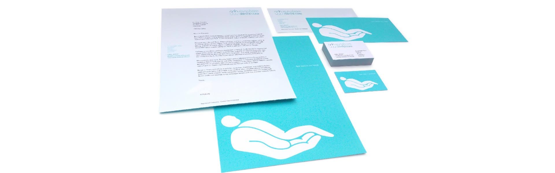 a set of letters and business cards for a dental care company