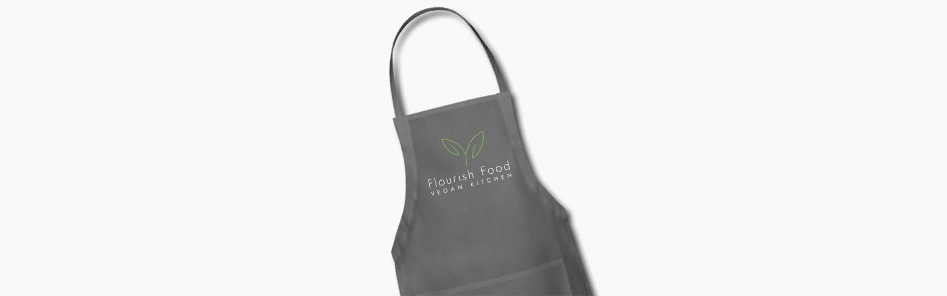 an apron with flourish food vegan kitchen written on it