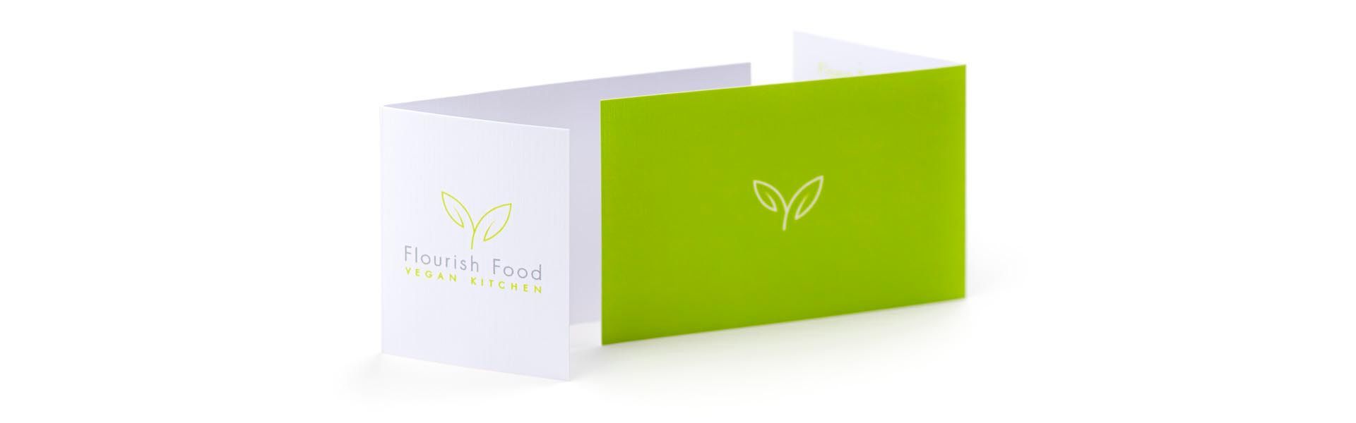 a green and white card for flourish food vegan kitchen