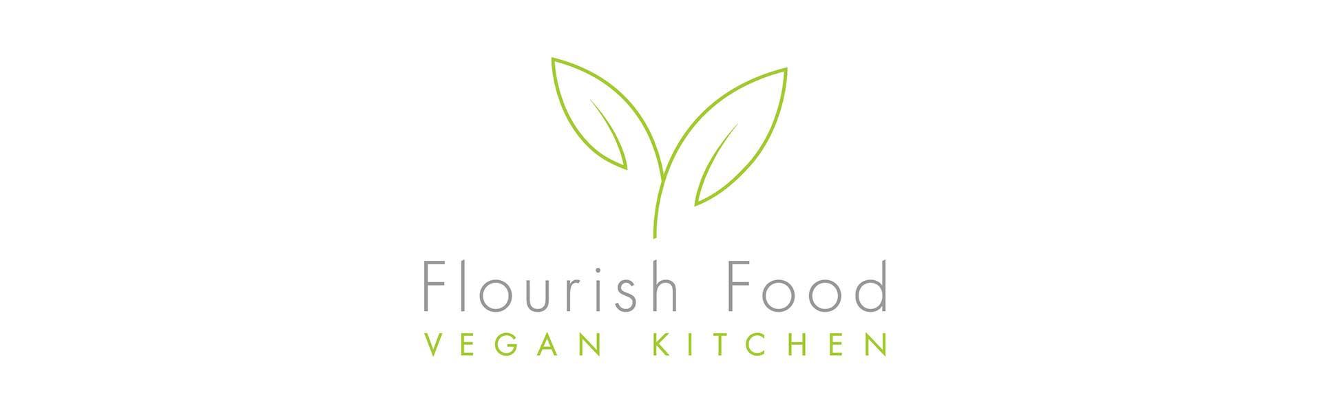 a logo for flourish food vegan kitchen with two green leaves