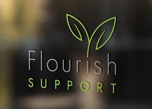 a logo for flourish support is on a glass window .