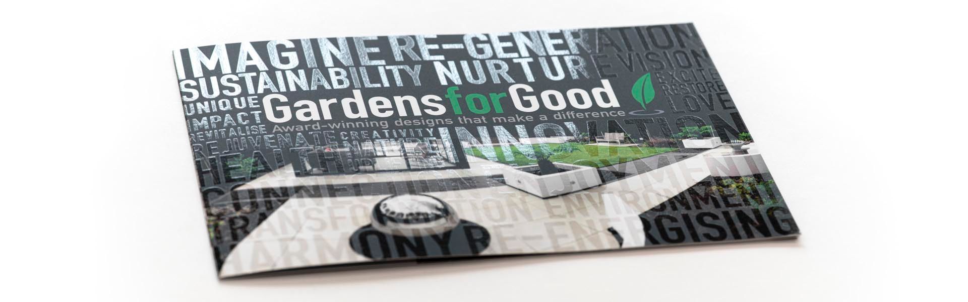 a brochure titled gardens for good is on a table