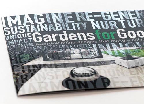 a brochure for gardens for good is sitting on a table .