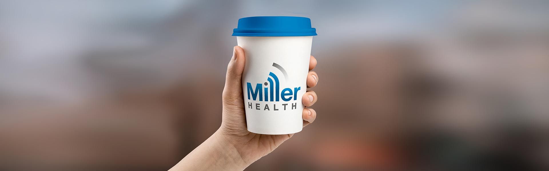 A person is holding a cup of miller health in their hand.