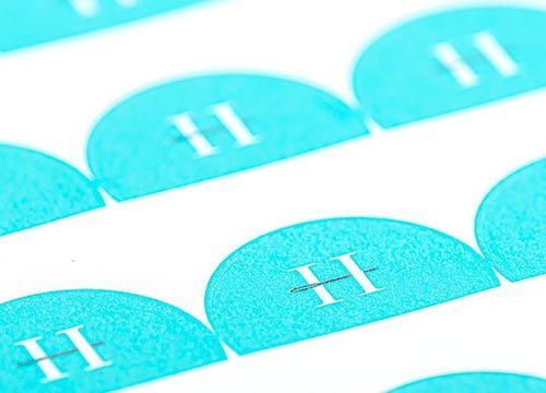 A close up of a row of blue circles with the letter h on them.
