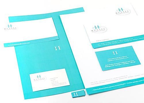A set of business cards , letters , and folders on a table.