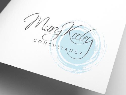 a close up of a logo for business coach mary keeley on a piece of paper.