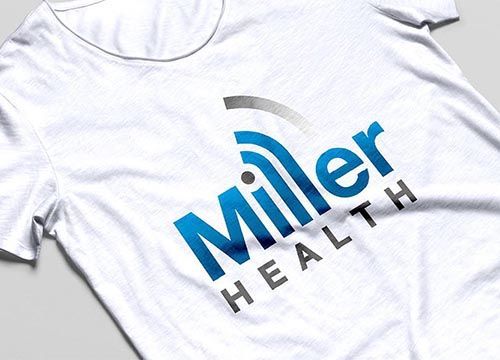a white t-shirt with a miller health logo on it .