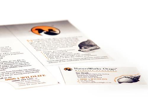a close up of a brochure and a business card on a table .