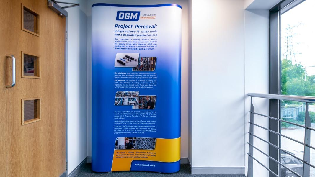 a blue and yellow sign that says ogm project perceval