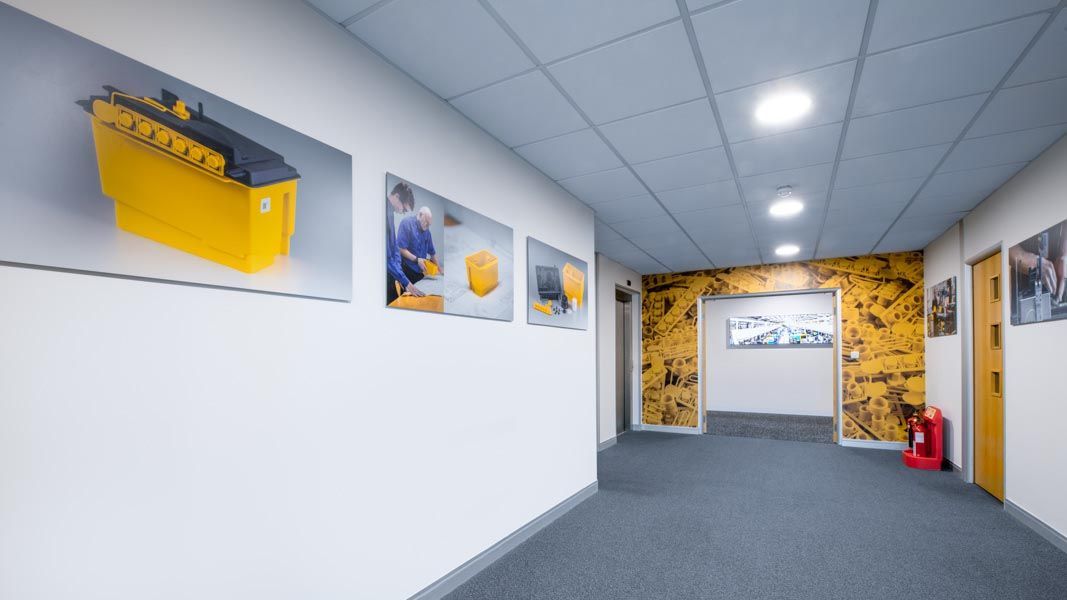 a hallway with a picture of a yellow box on the wall