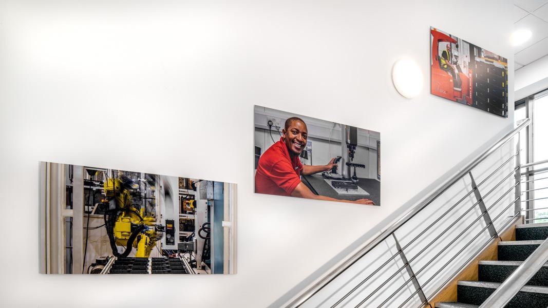 a man in a red shirt is working on a machine