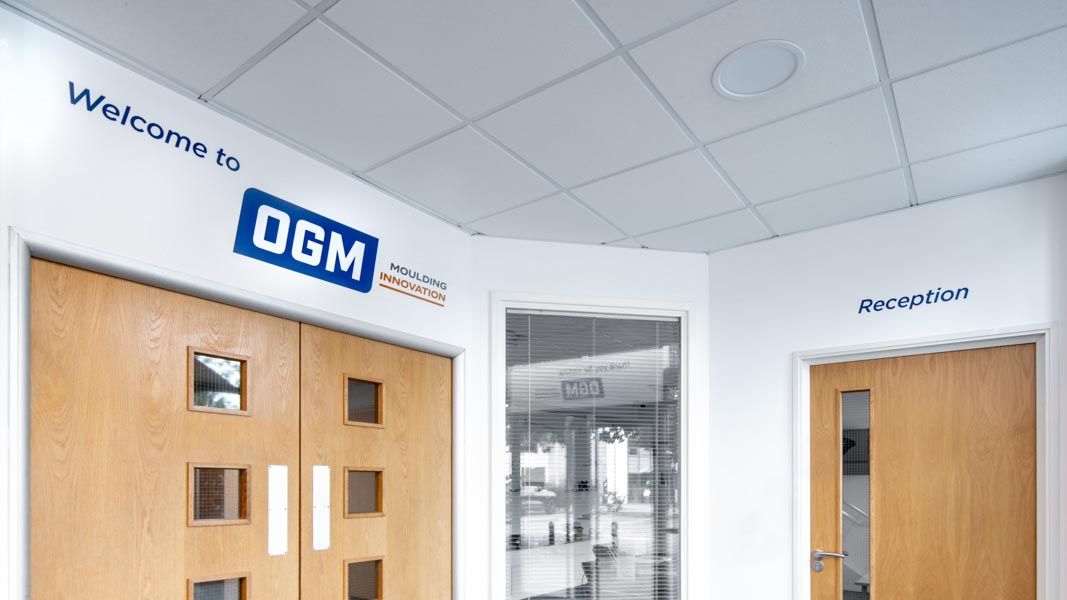 A room with wooden doors and a sign that says welcome to ogm