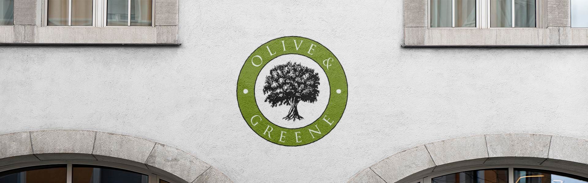 a sign on a building that says olive & greene