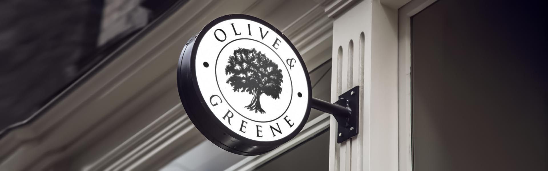 a sign on the side of a building that says olive & greene