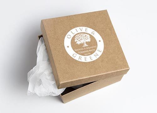 a brown box with a tree on it is filled with soap .