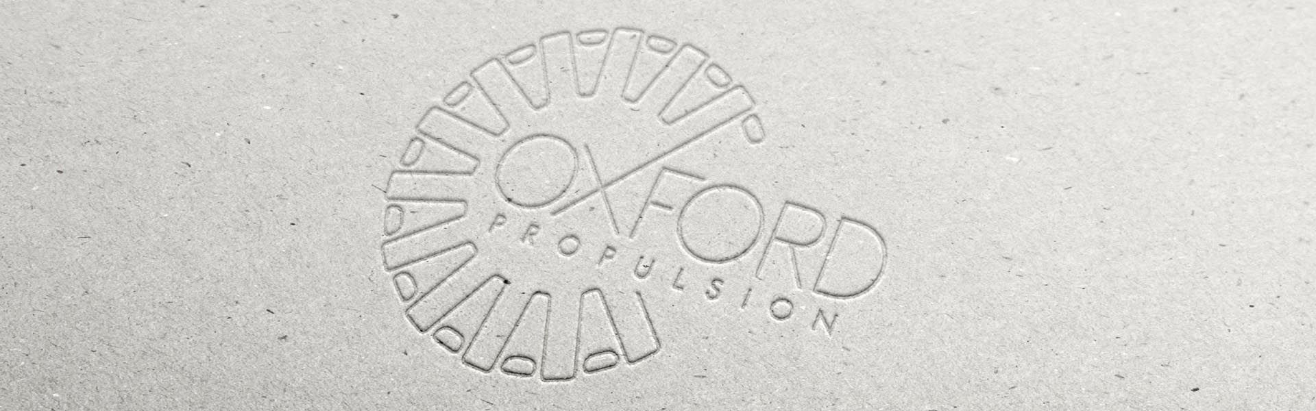 a logo for oxford propulsion is embossed into a piece of cardboard
