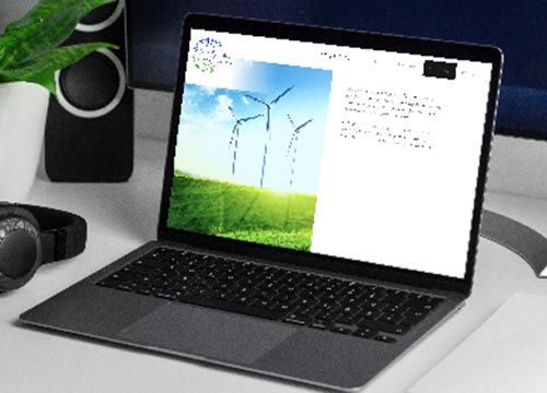 a laptop is open to a website page with a picture of electric wind turbines on it
