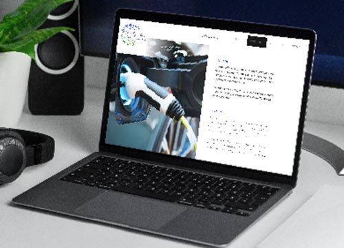 a laptop with a picture of an electric car on the screen