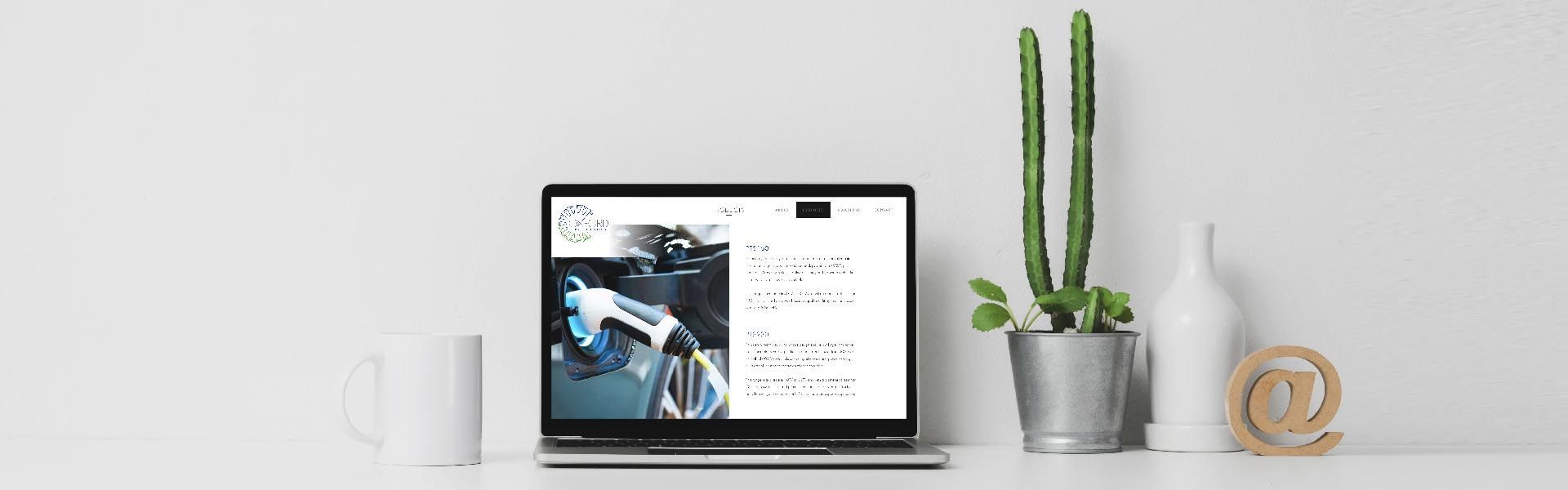 a laptop is open to a website page with a picture of an electric car on it