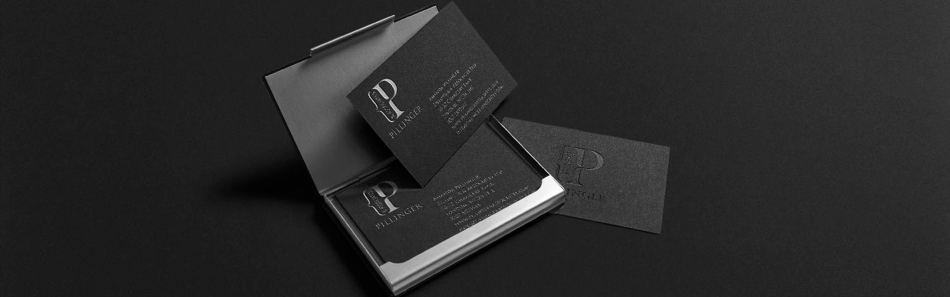 a black business card with the pillinger & associates logo on it