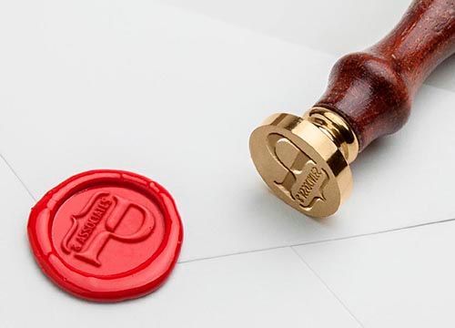 a close up of a wax seal on a piece of paper .