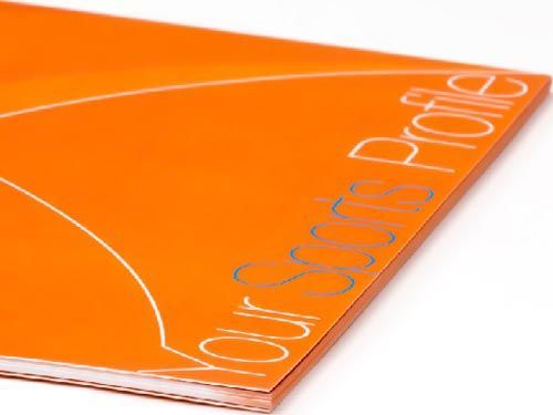 a close up of an orange sports profile book for play dna.
