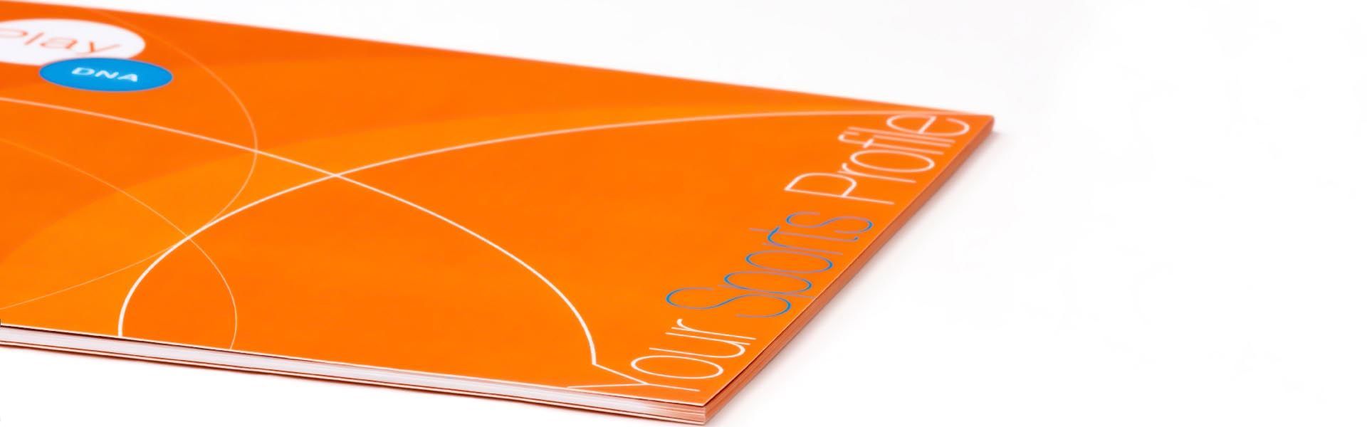 an orange book with the words your sports profile on it
