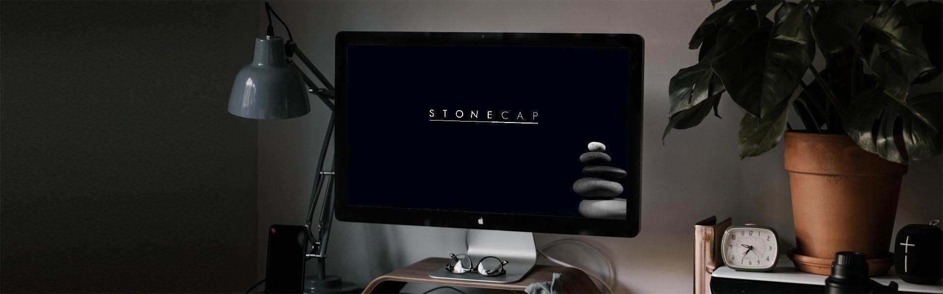 an iMac with the stonecap logo on it
