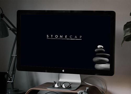an iMac with the stonecap logo on the screen