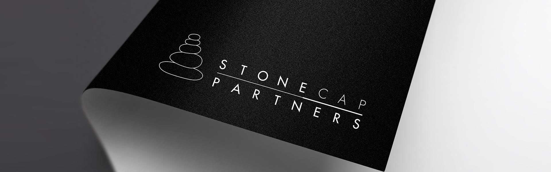 a black piece of paper with stonecap partners logo on it