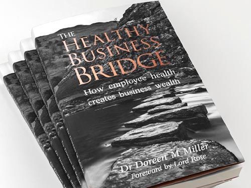 a stack of books titled the healthy business bridge by dr doreen miller.