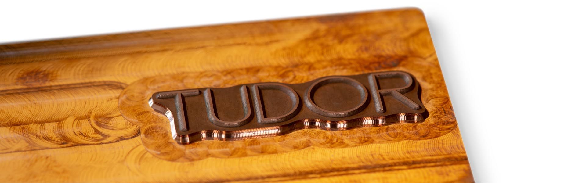 the word tudor is milled out of a piece of copper as an embossing die
